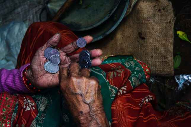 person holding coins