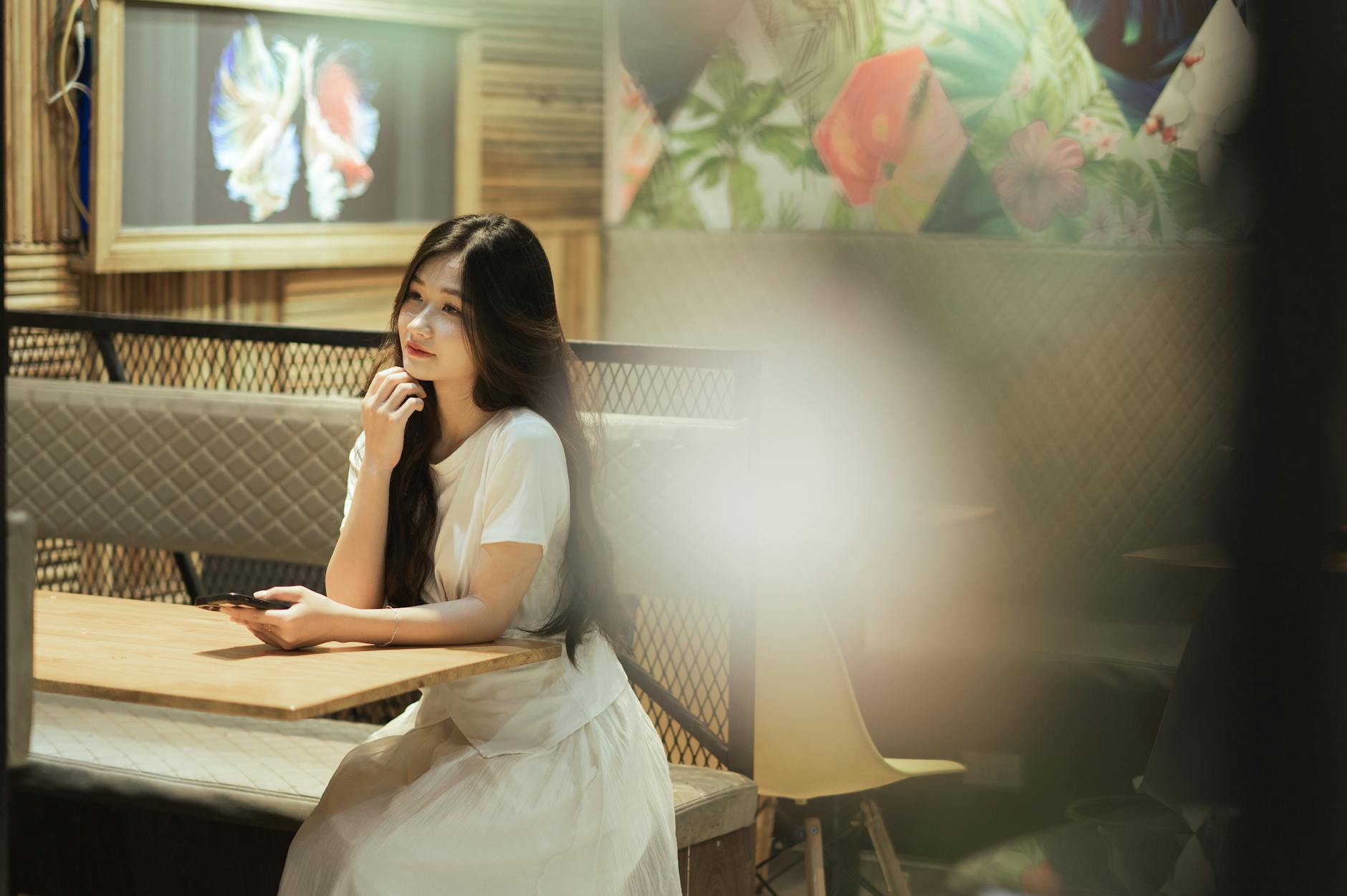 woman sitting at the cafeteria and thinking