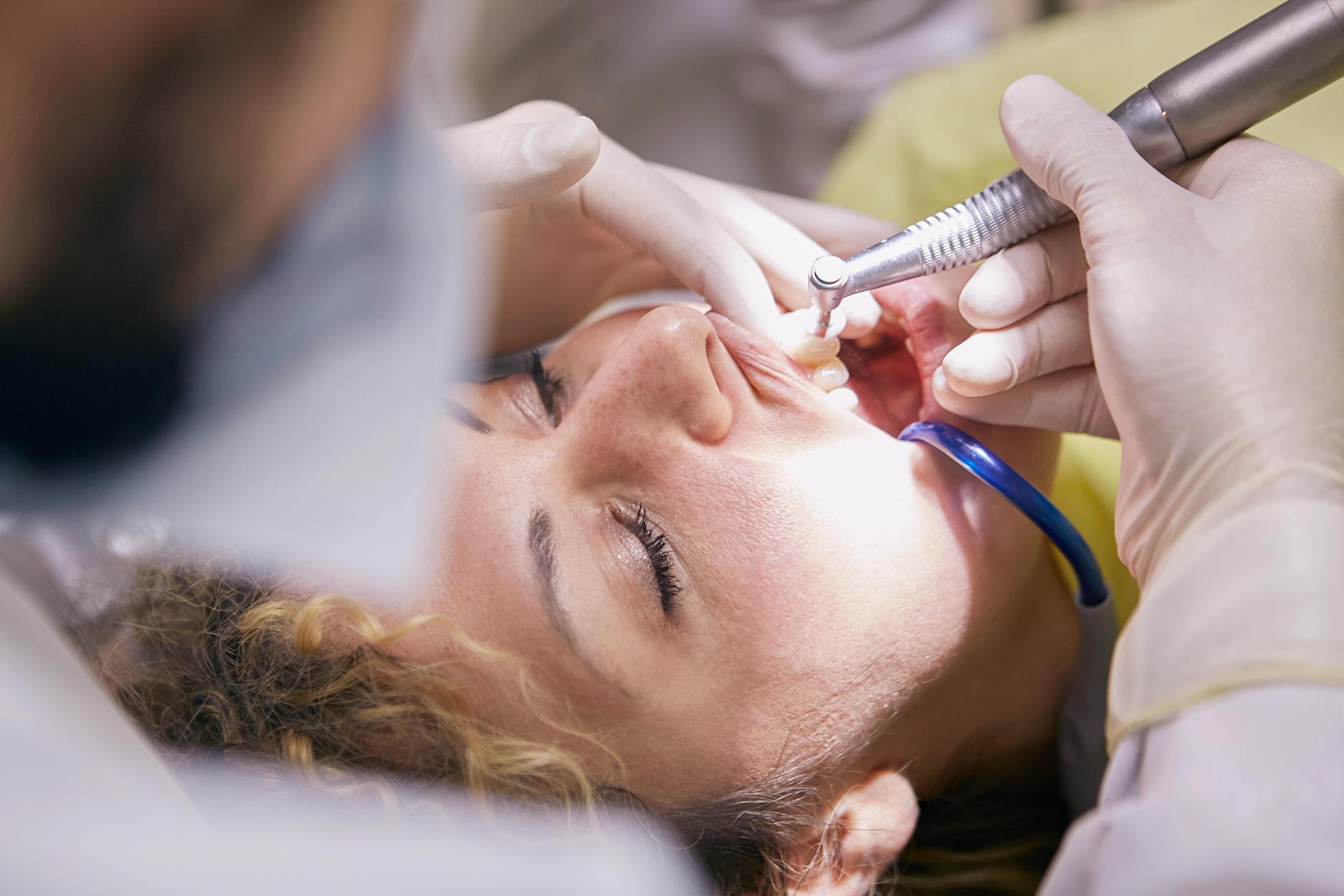 woman s teeth being clean by dentist