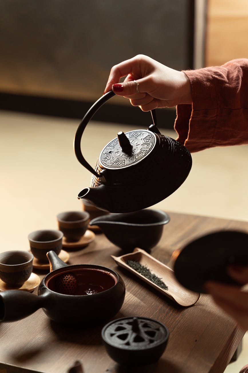 woman hand holding traditional teapot