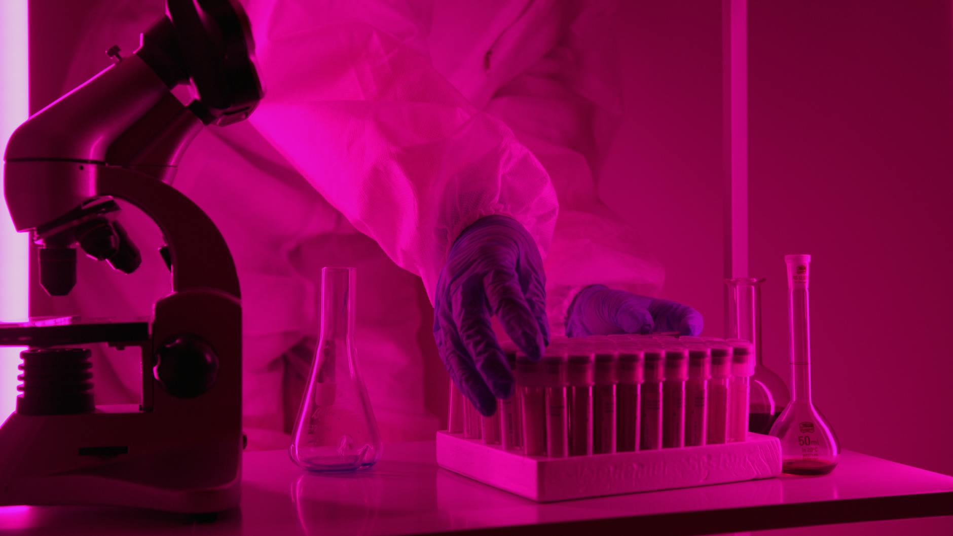 scientist holding container with vials