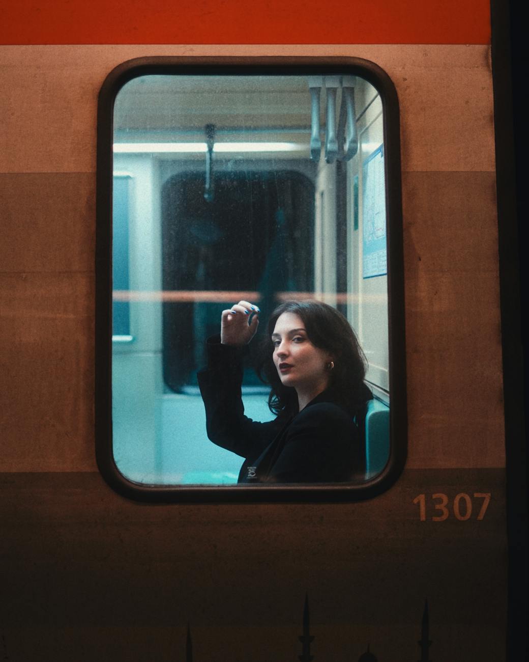 a woman sitting inside a subway train